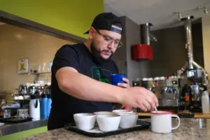 ai proof job - person cupping coffee and scoring it with the coffee value assessment